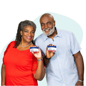 African American couple smiling and holding Medicare cards